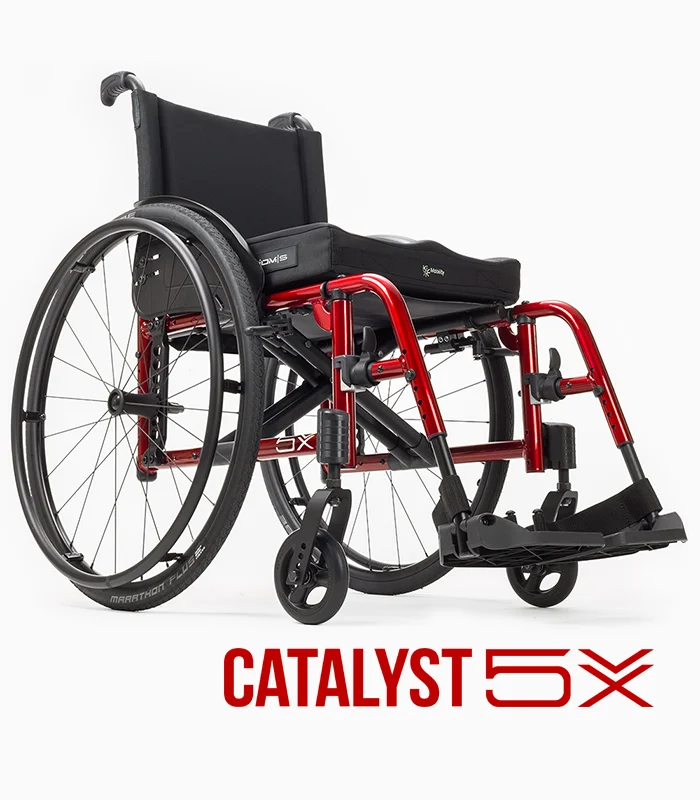 Ki Mobility Catalyst 5X wheelchair with red frame, angled view.