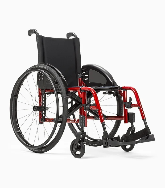 Ki Mobility Catalyst wheelchair with red frame, angled view.