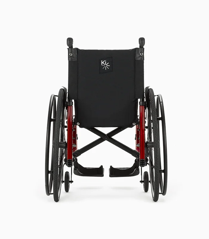 Ki Mobility Catalyst wheelchair with red frame, rear view.