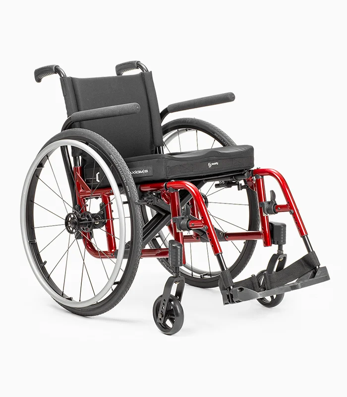 Ki Mobility Catalyst wheelchair with red frame, angled view.
