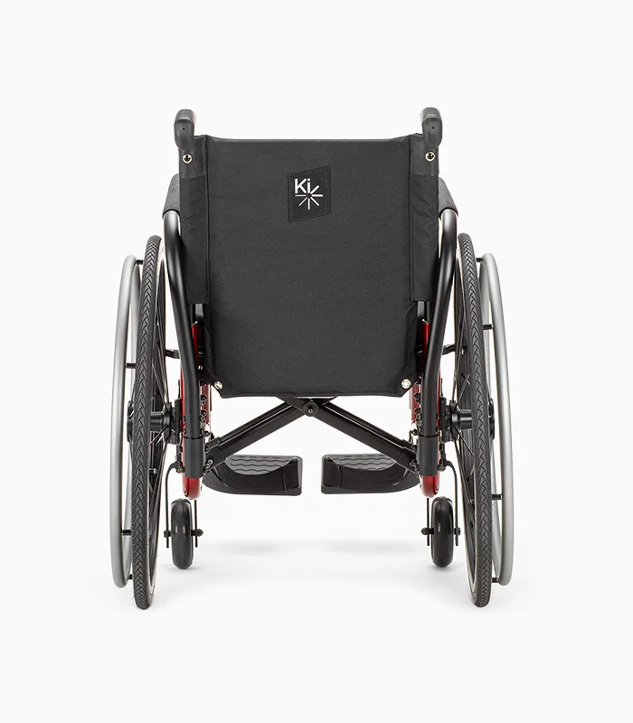 Ki Mobility Catalyst wheelchair with red frame, rear view.