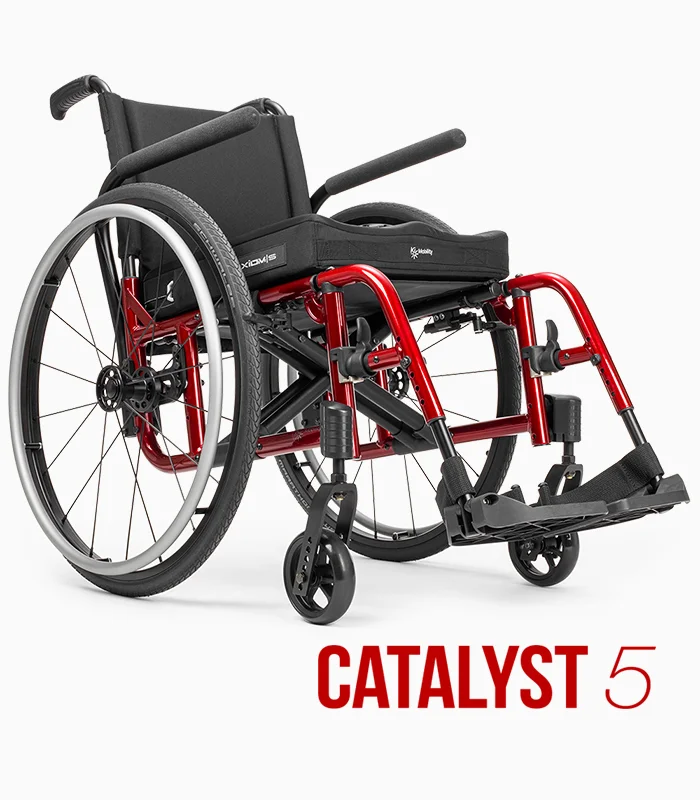 Ki Mobility Catalyst 5 wheelchair with red frame, angled view.