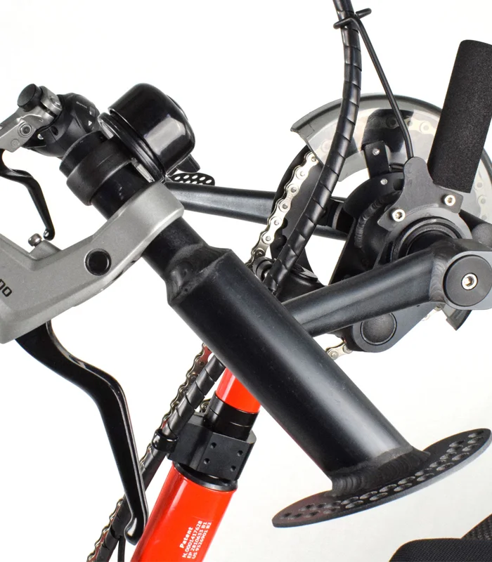 Close-up of the TriBike's hand-crank pedal, chain, and gear shifter mechanism.