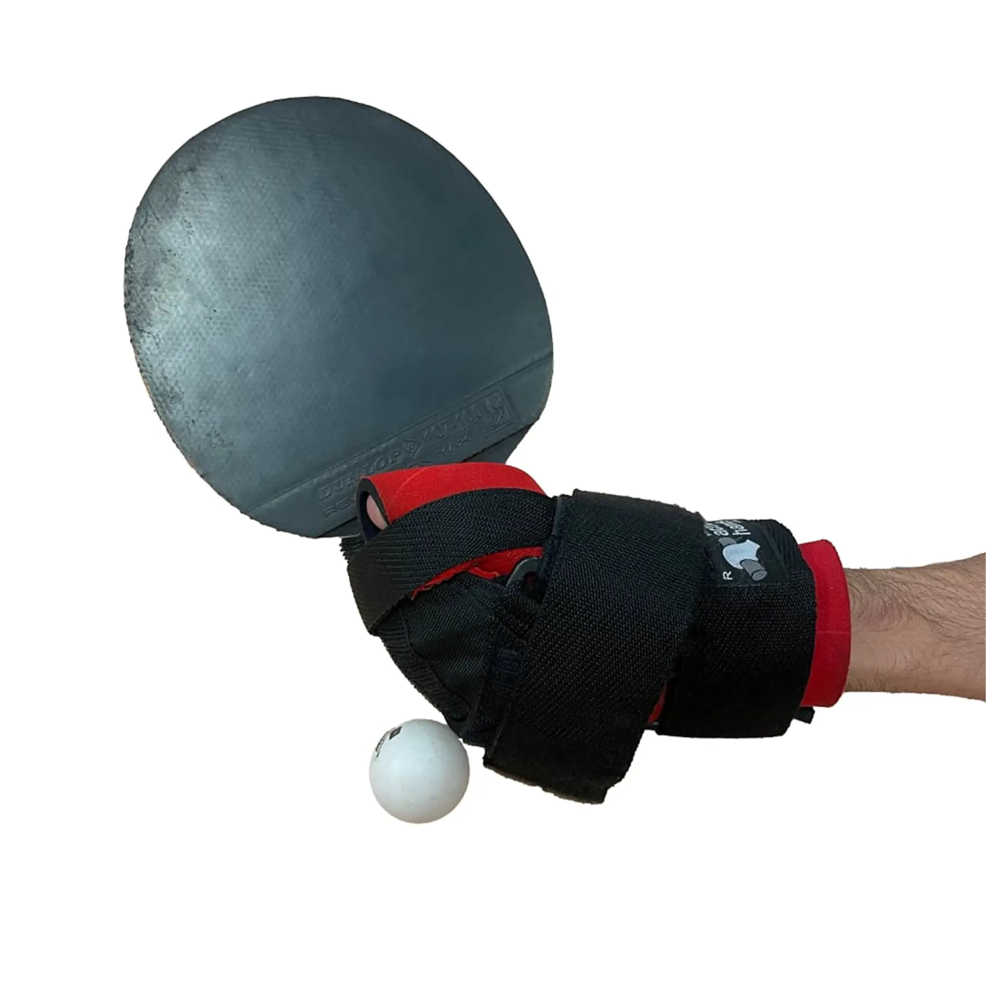 Hand wearing a red and black wrist aid gripping a table tennis paddle, with a ball nearby.