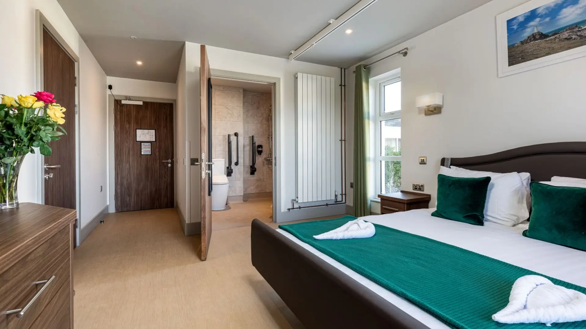 Hotel room with accessible ensuite bathroom visible.