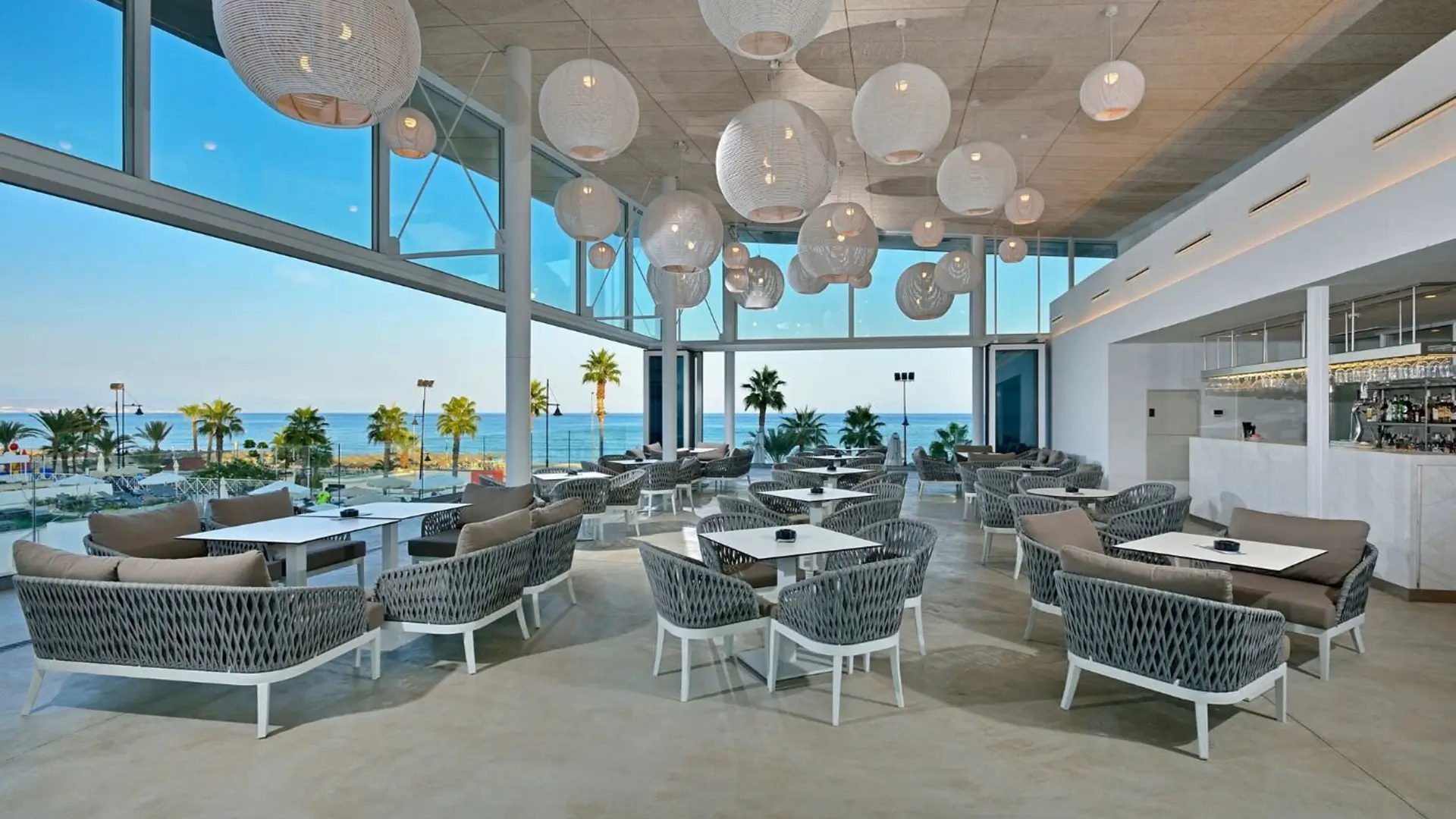 Oceanview lounge with hanging lantern lights.