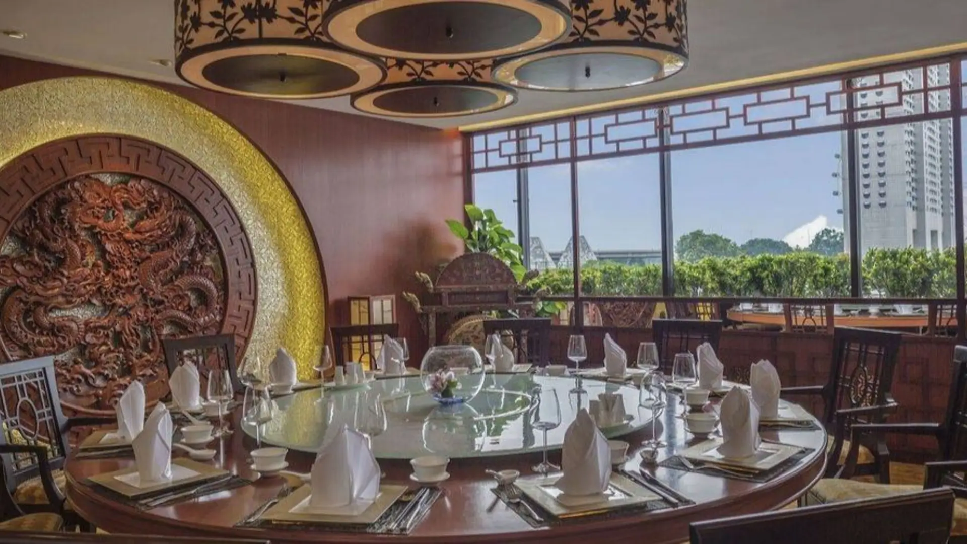 Chinese restaurant with round table and dragon carving.
