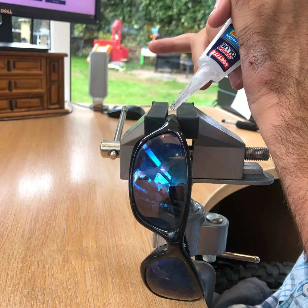 Adult Using Active Hands Desktop Clamp To Hold Sunglasses In Place