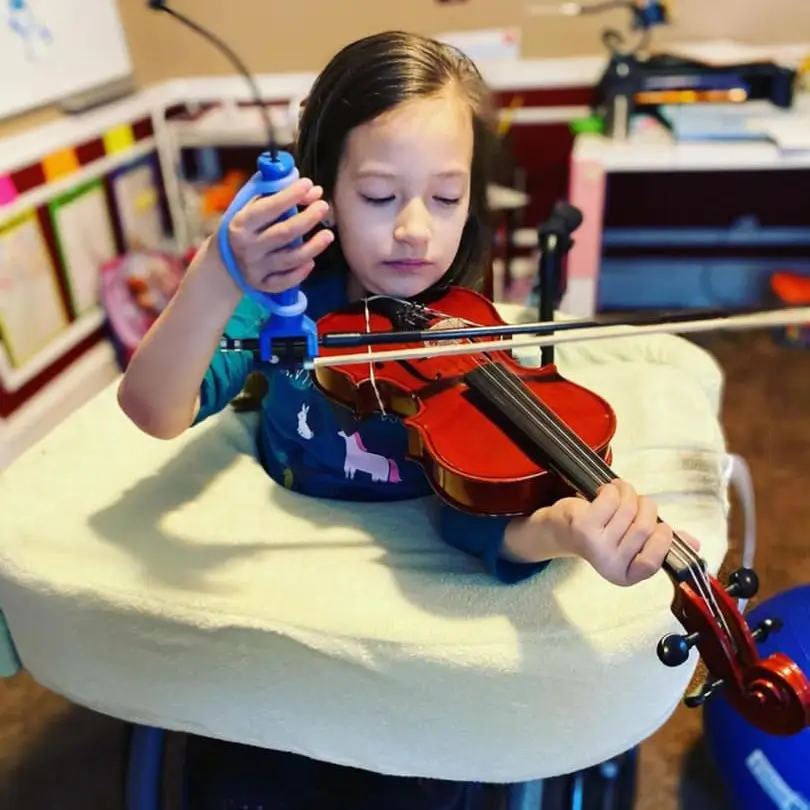 Child Using The Functional Hand To Play A Musical Instrument