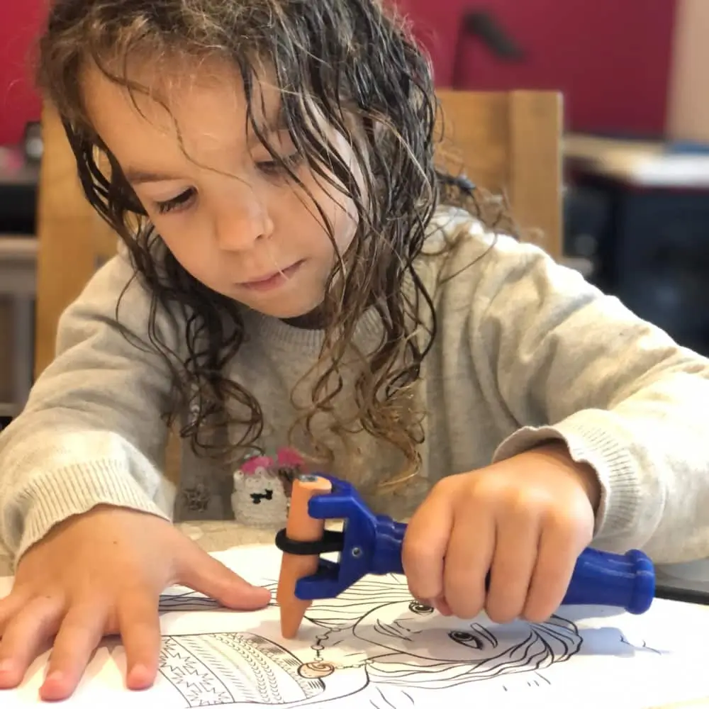 Child Using The Functional Hand To Draw