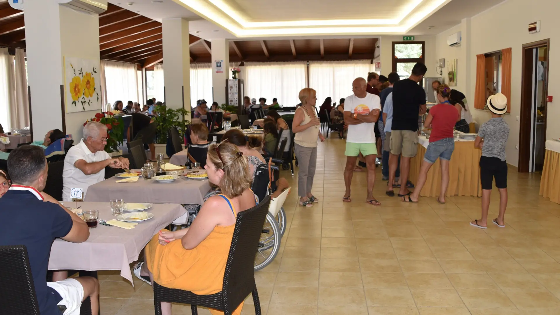 Guests dining and mingling in hotel restaurant.