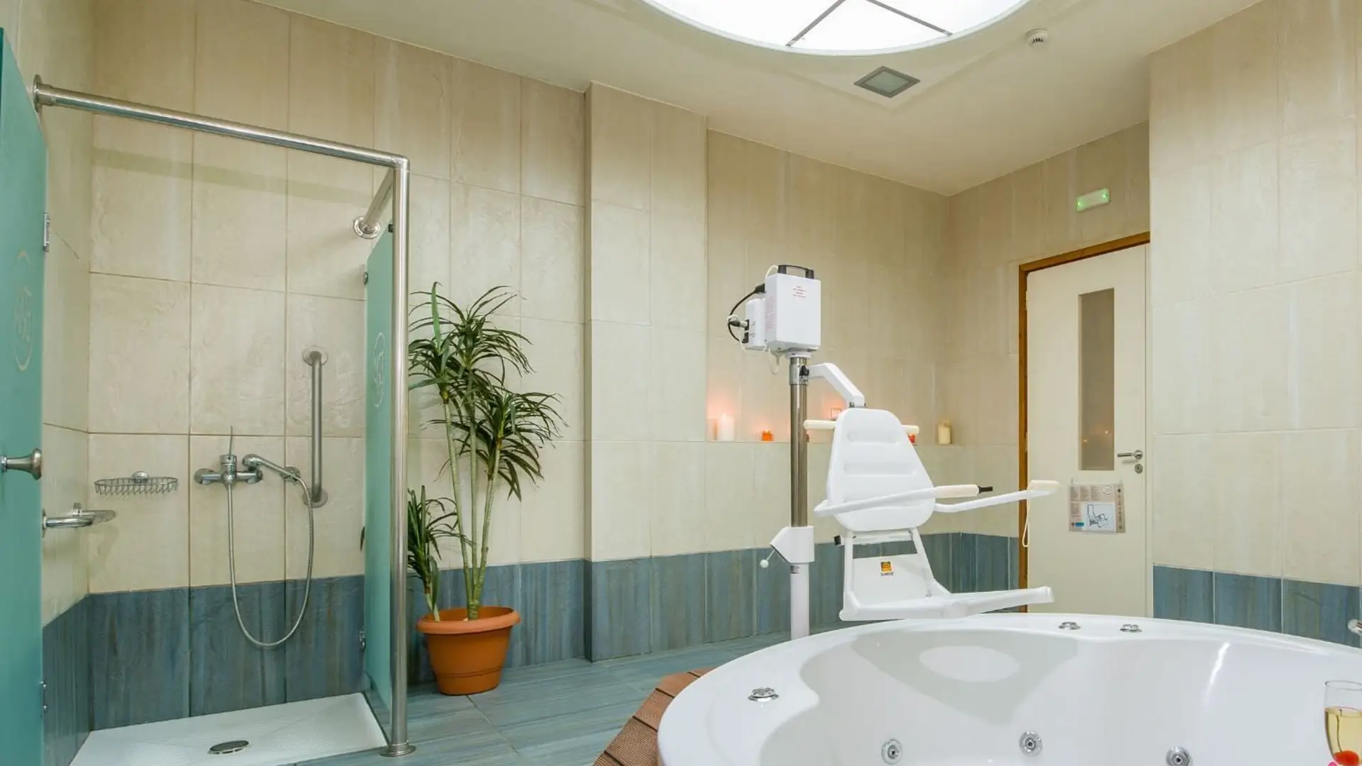 Spa bathroom with bath hoist chair over tub.