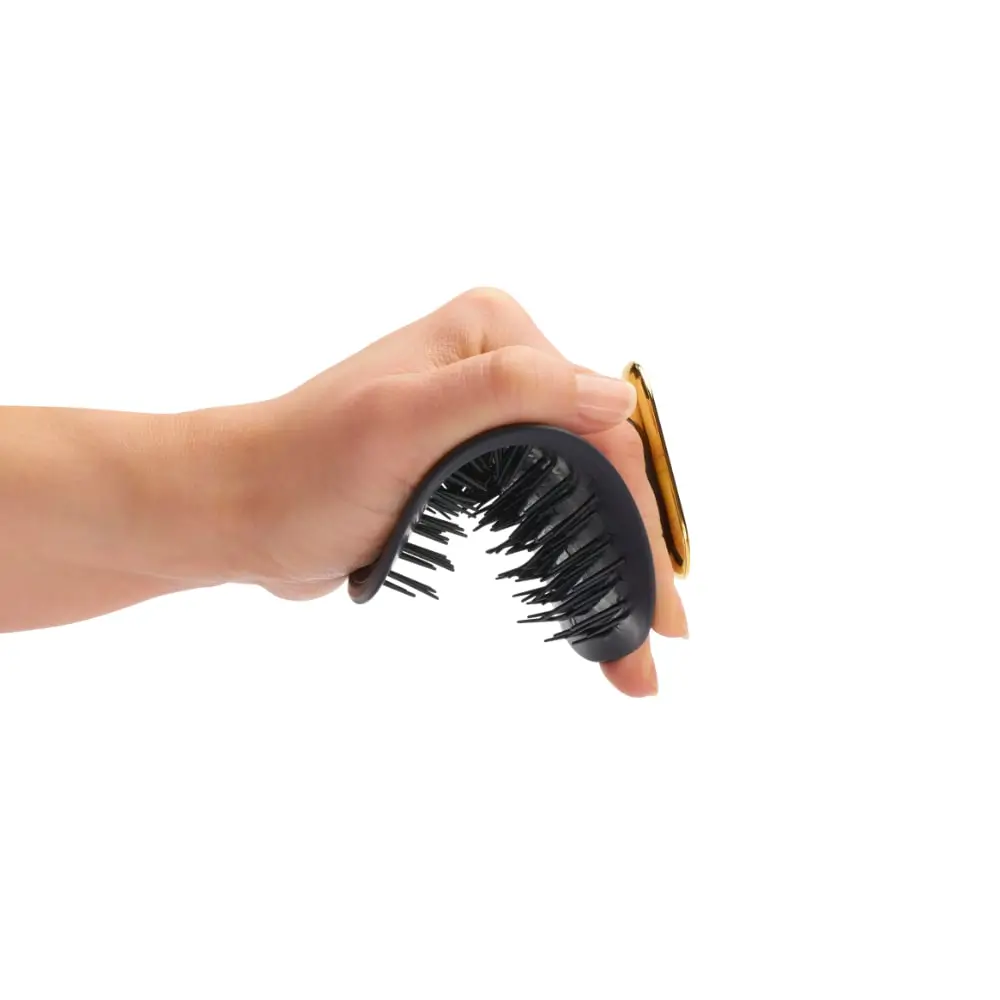 Person Holding The Manta Healthy Hair Brush
