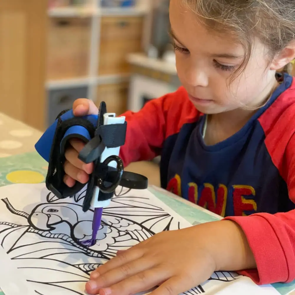 Child Holding An Pen Using The Mini Small Item Aid