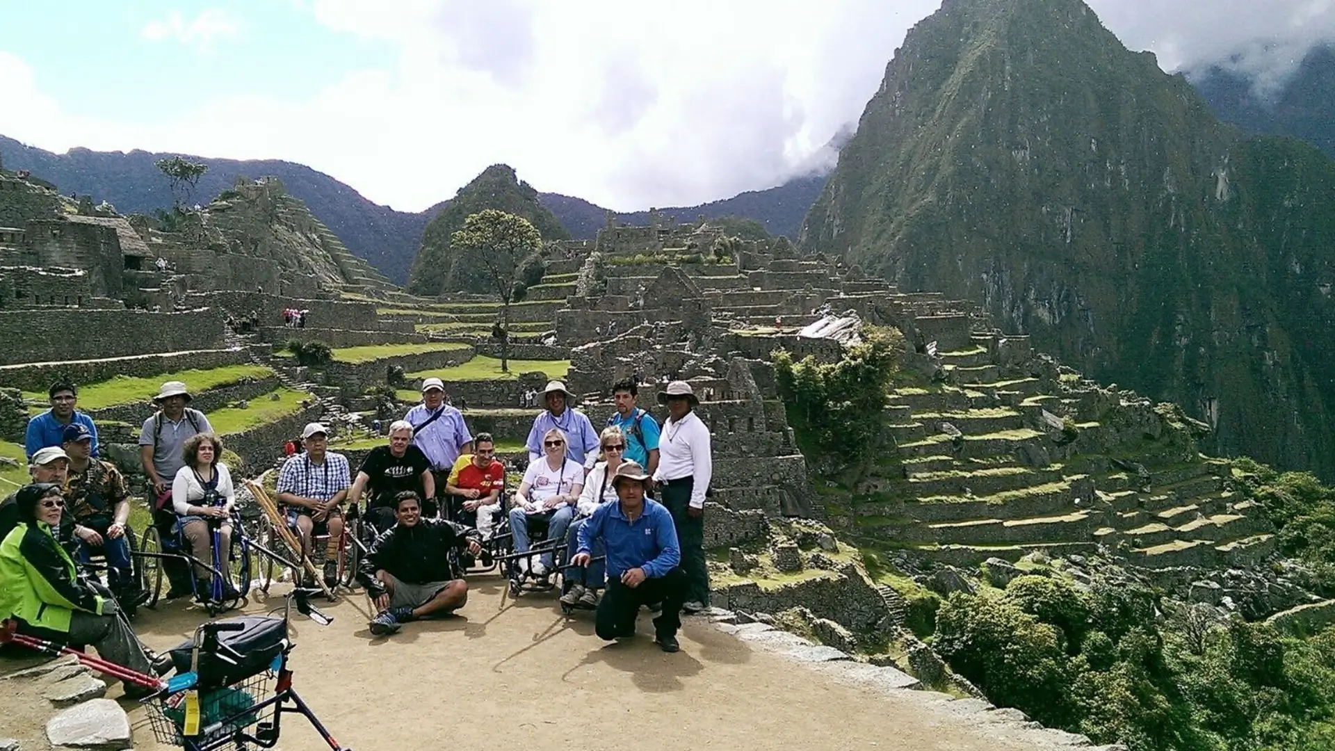 Group with wheelchairs posing at Machu Picchu.