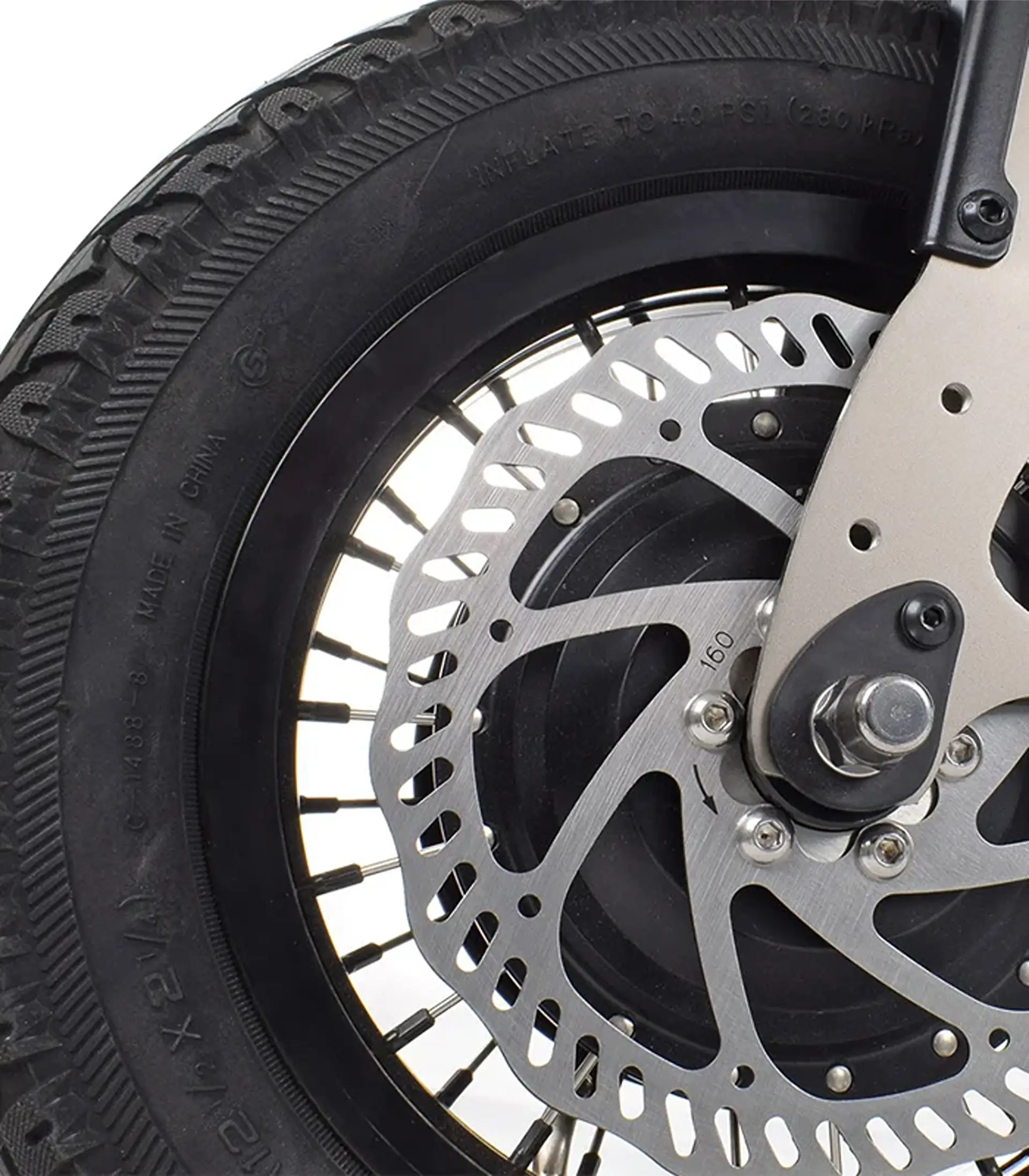 Close-up of the front wheel's disc brake and knobby tire on the Triride Light.