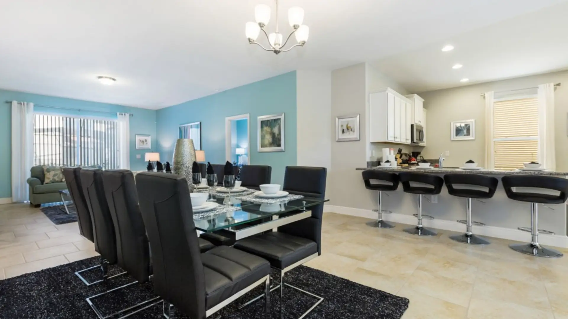 Open dining and kitchen area with bar stools.