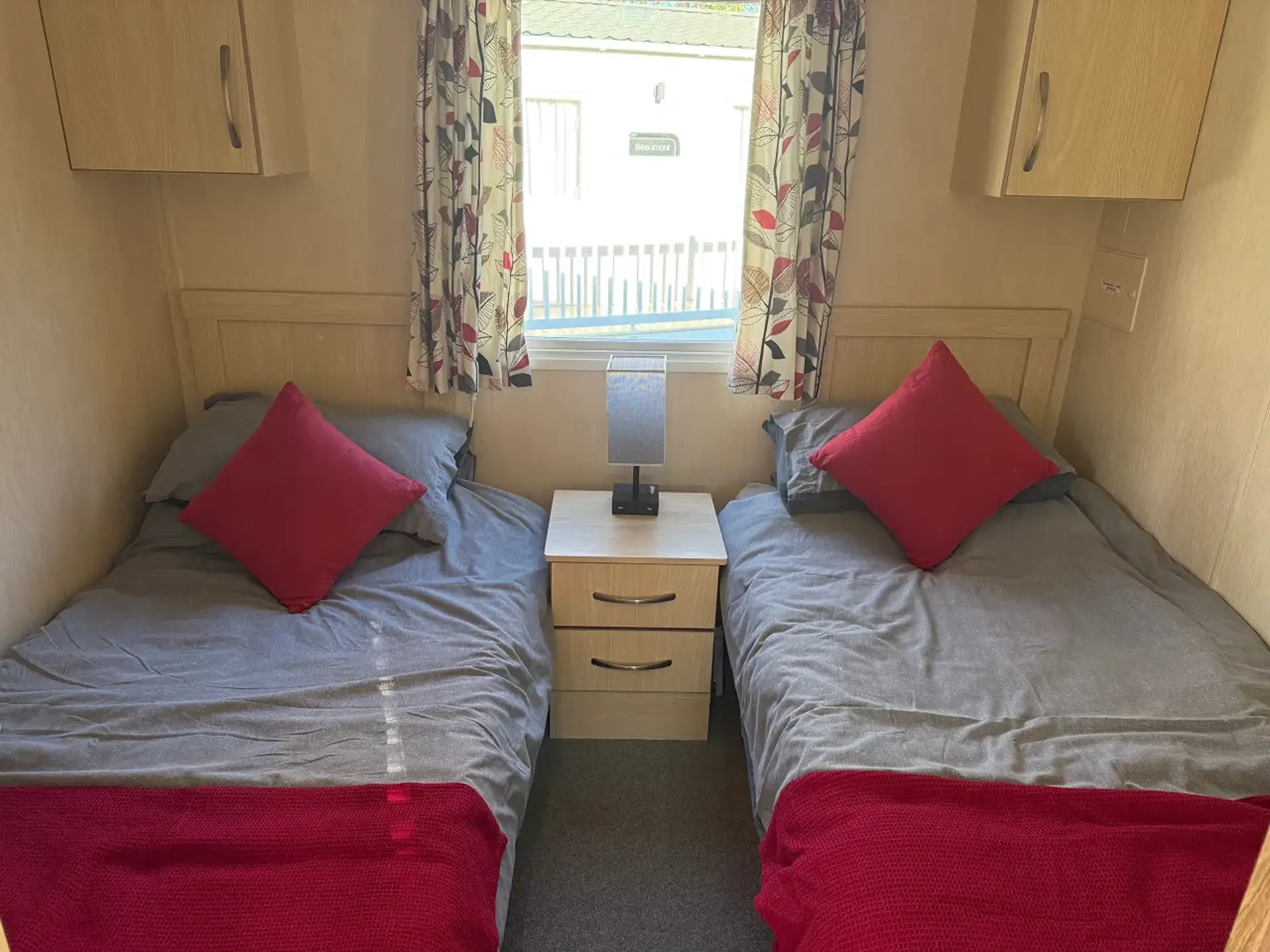 Twin bedroom with two single beds either side of a bedside table.