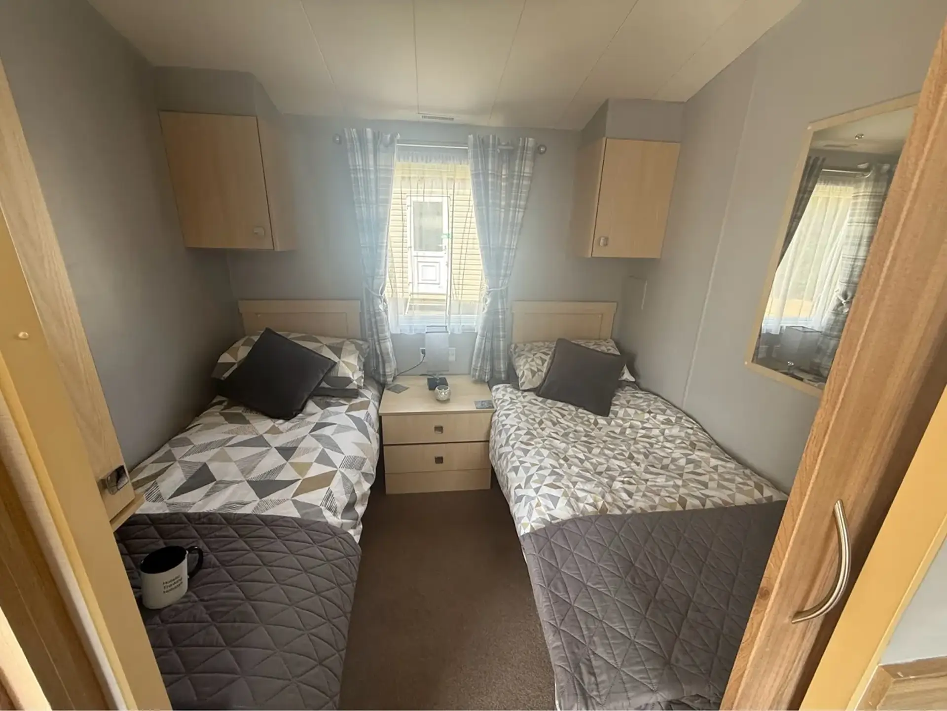 Twin bedroom with two single beds either side of a bedside table.
