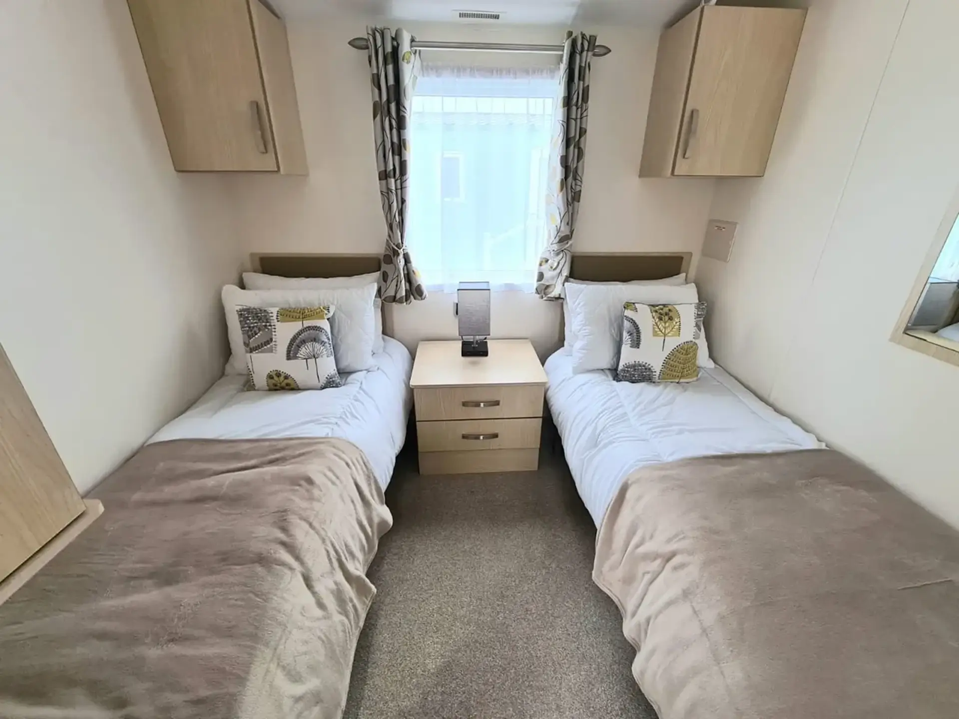 Twin bedroom with two single beds either side of a bedside table.