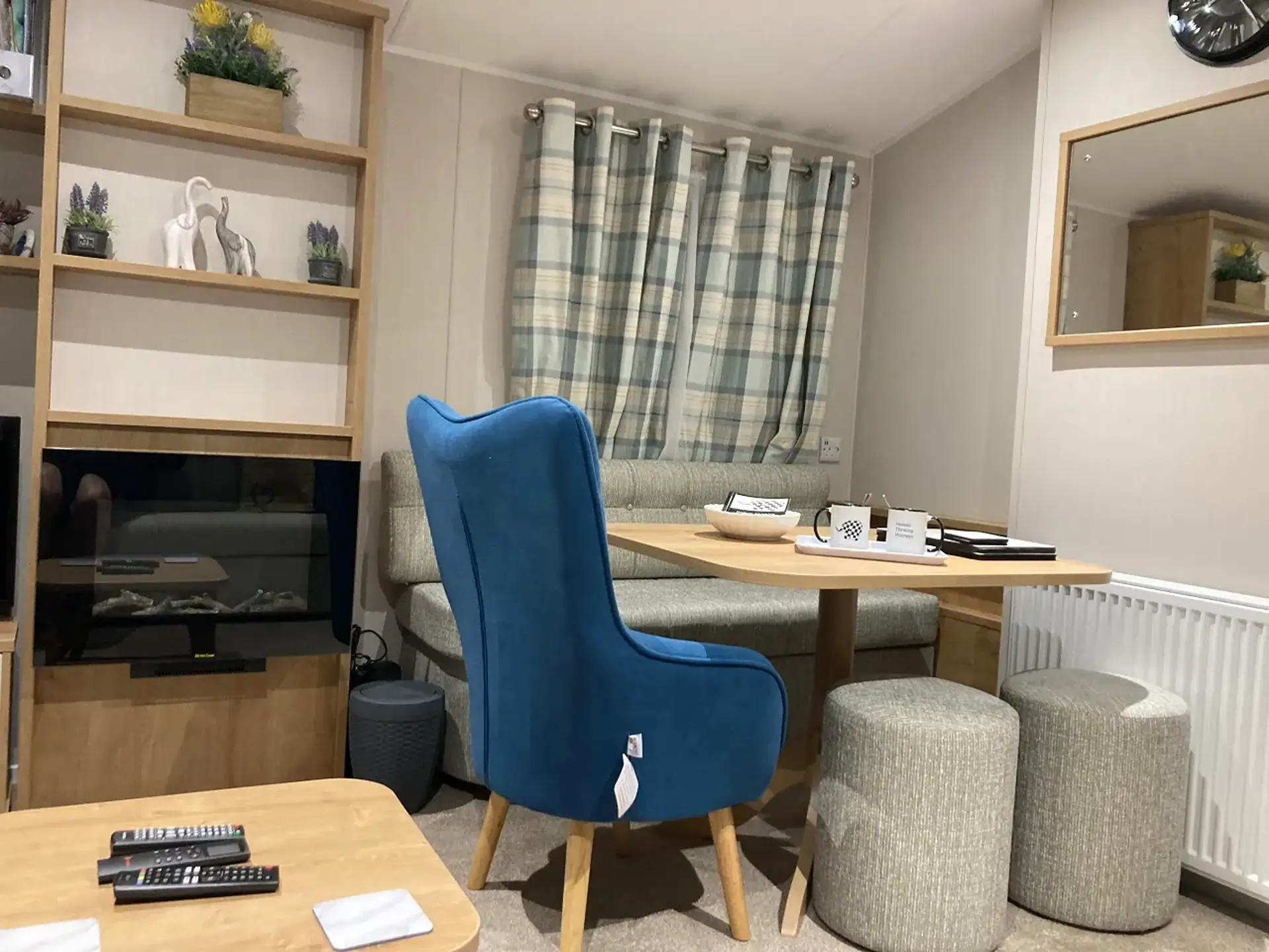 Lounge dining nook with blue accent chair and grey bench seating.