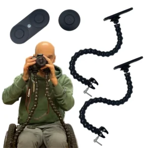 Man in wheelchair holding camera on dual flexible arm mounts attached to chair.