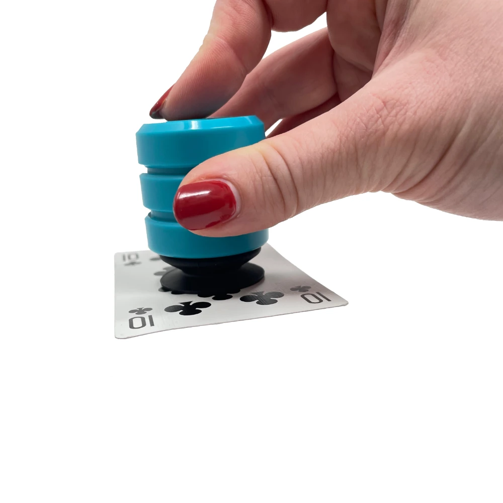 Fingers pressing teal grip tool onto a 10 of clubs.