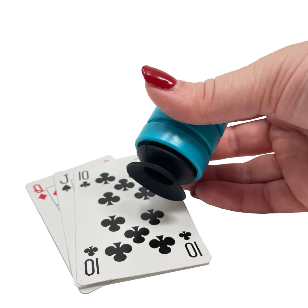 Side view of teal grip tool lifting off playing cards.