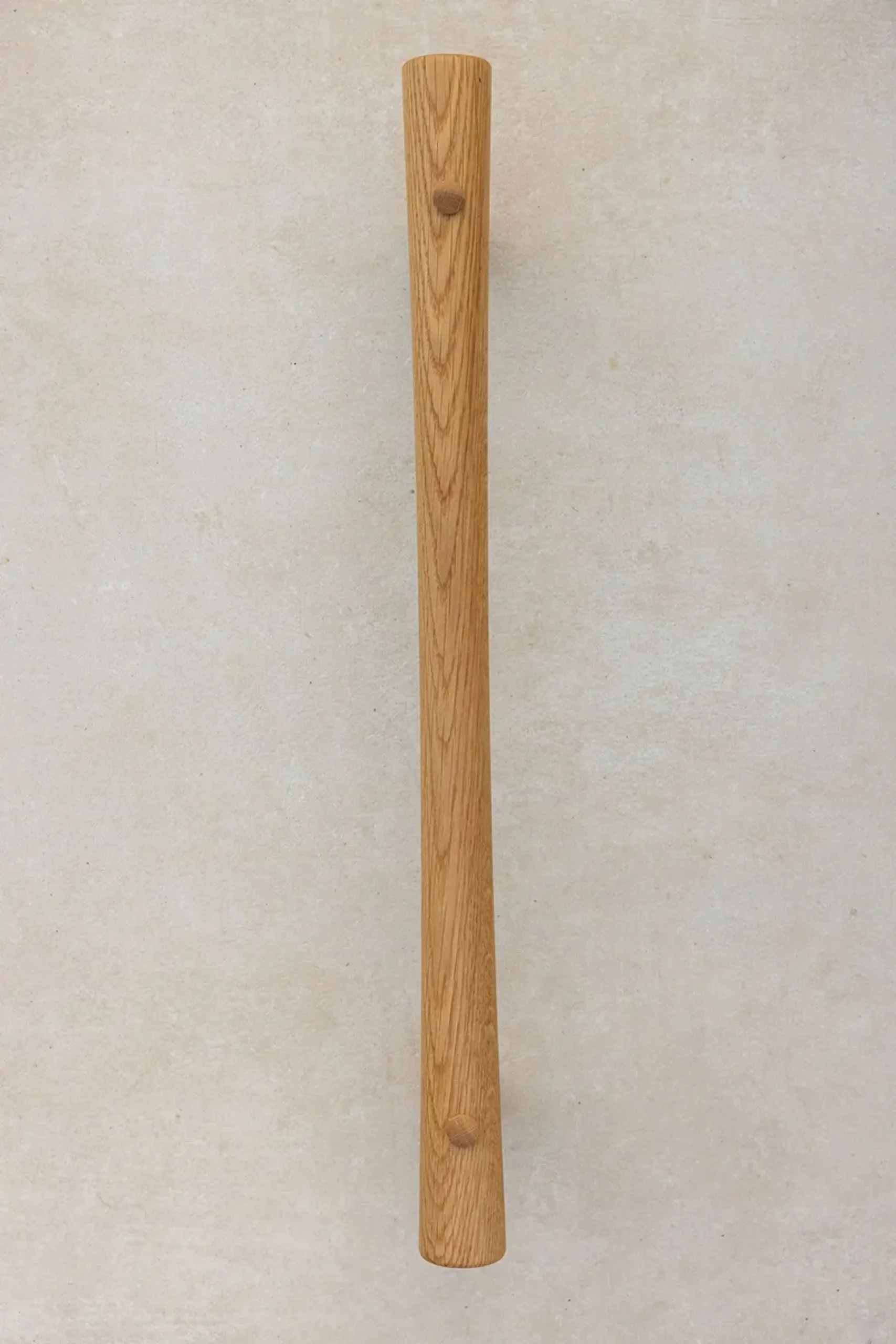 Two oak grab rails of different lengths lying flat side by side.