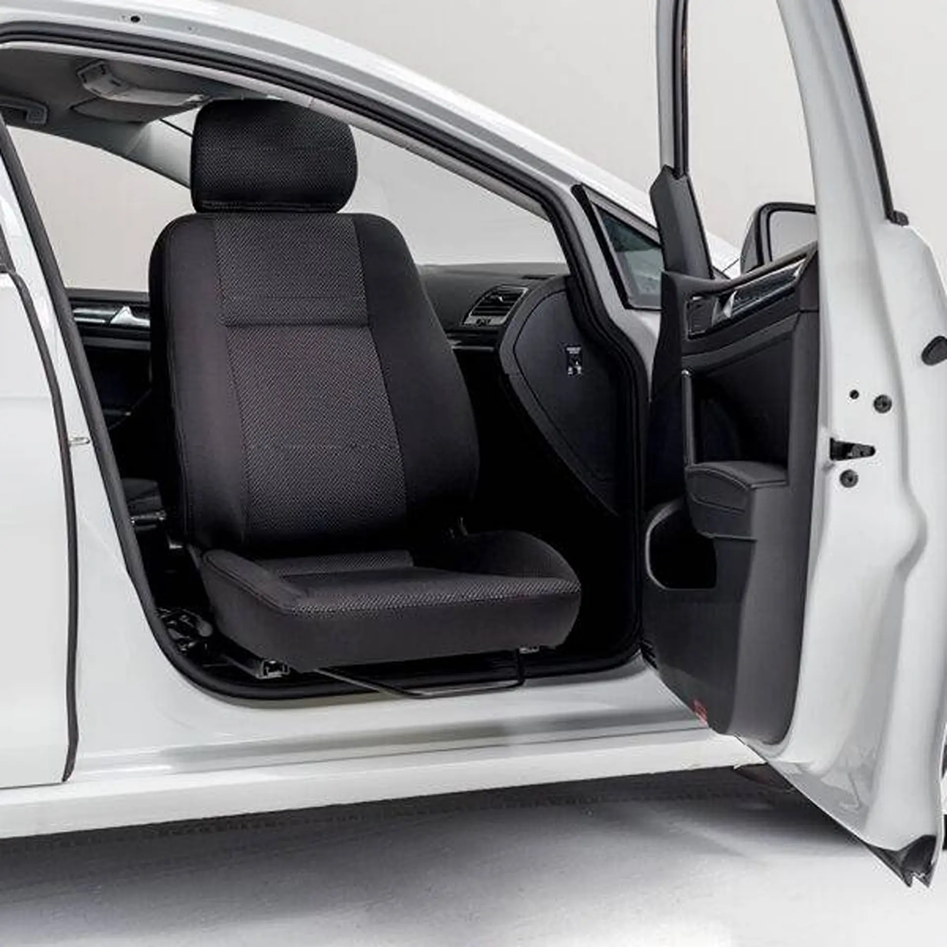 Car's front seat rotated outward through the open door, empty interior.
