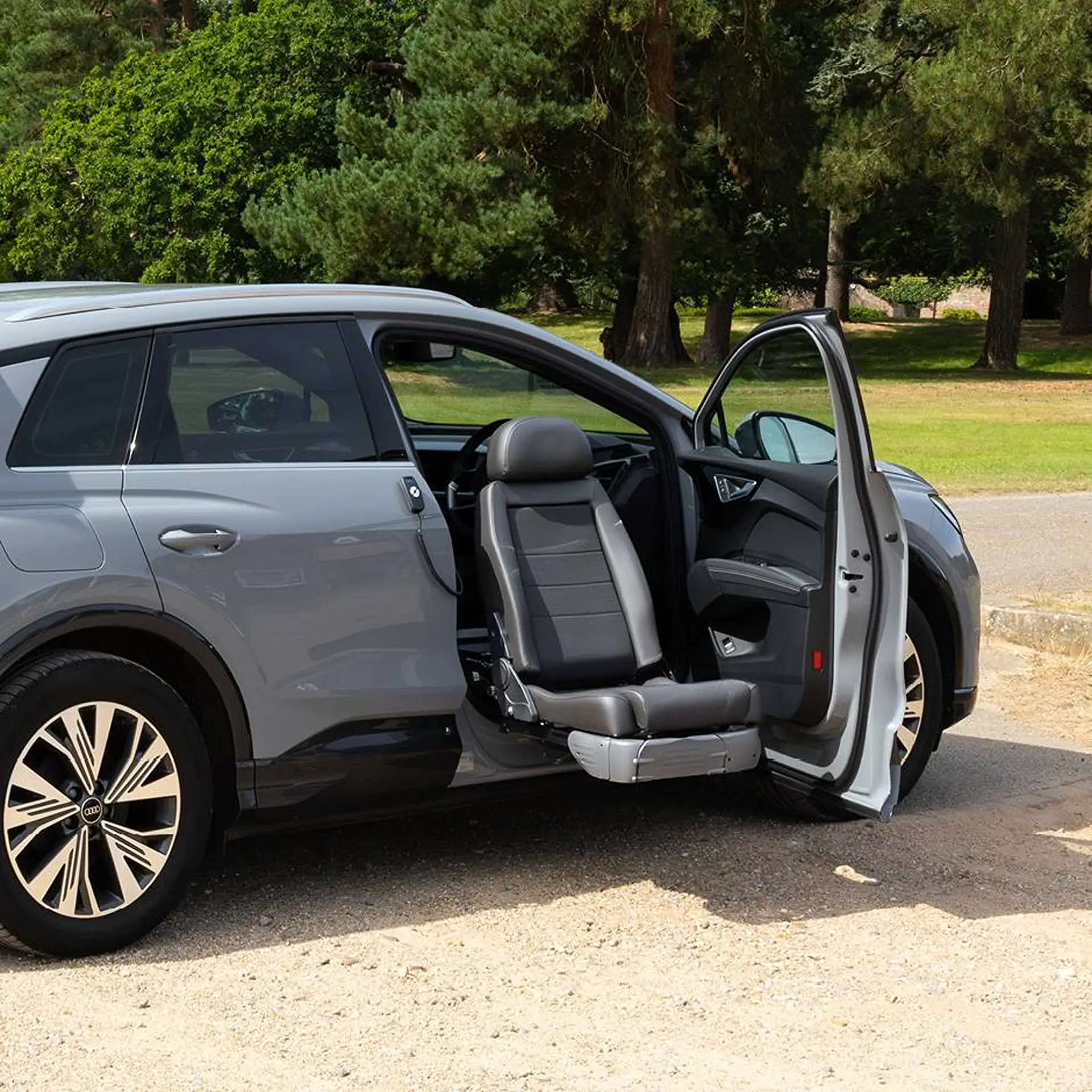 Audi SUV with front seat swivelled and extended out through the open door.