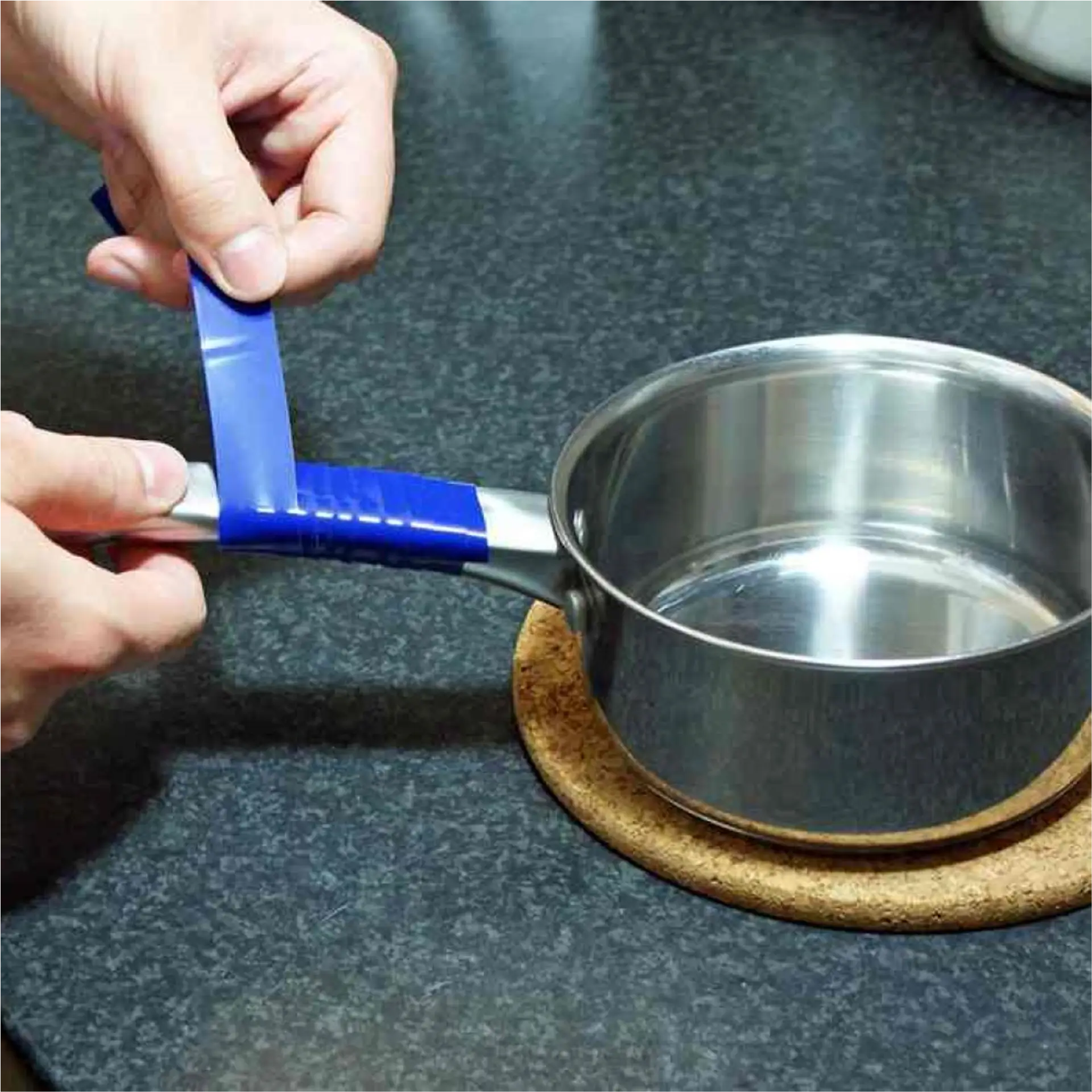Hand attaching blue strap to pot handle.