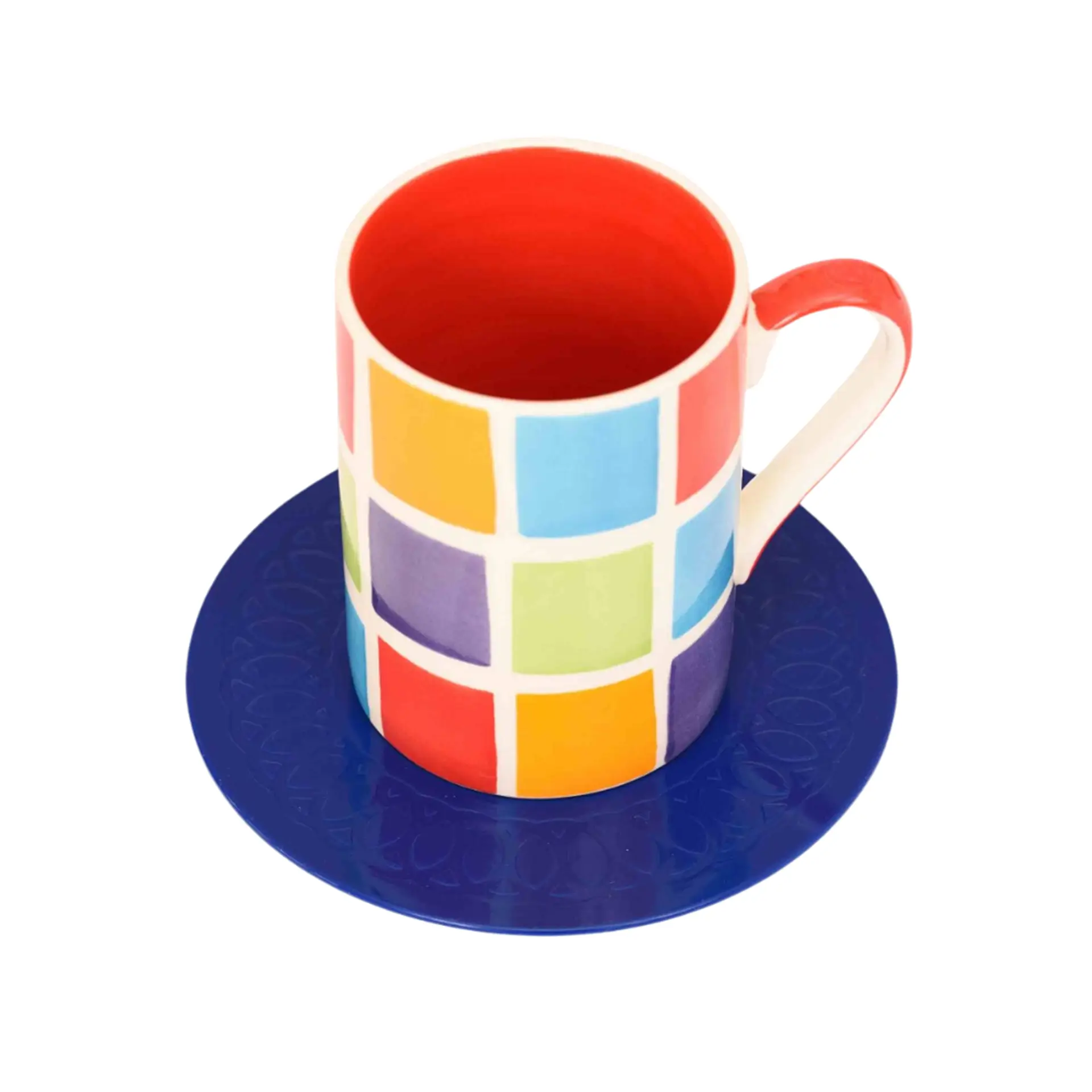 Colorful mosaic mug on matching blue saucer.