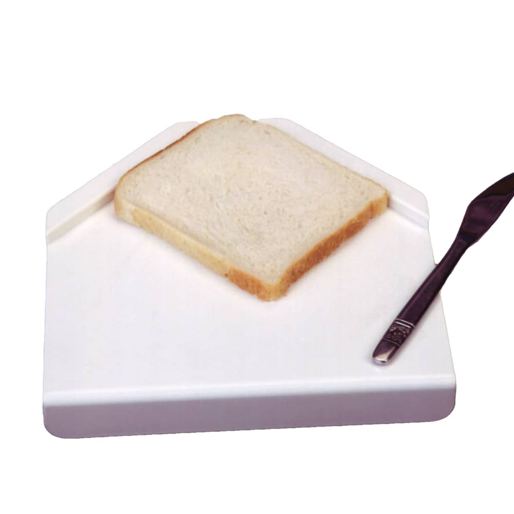 Bread with corner guides on one-handed spreading board, knife alongside.