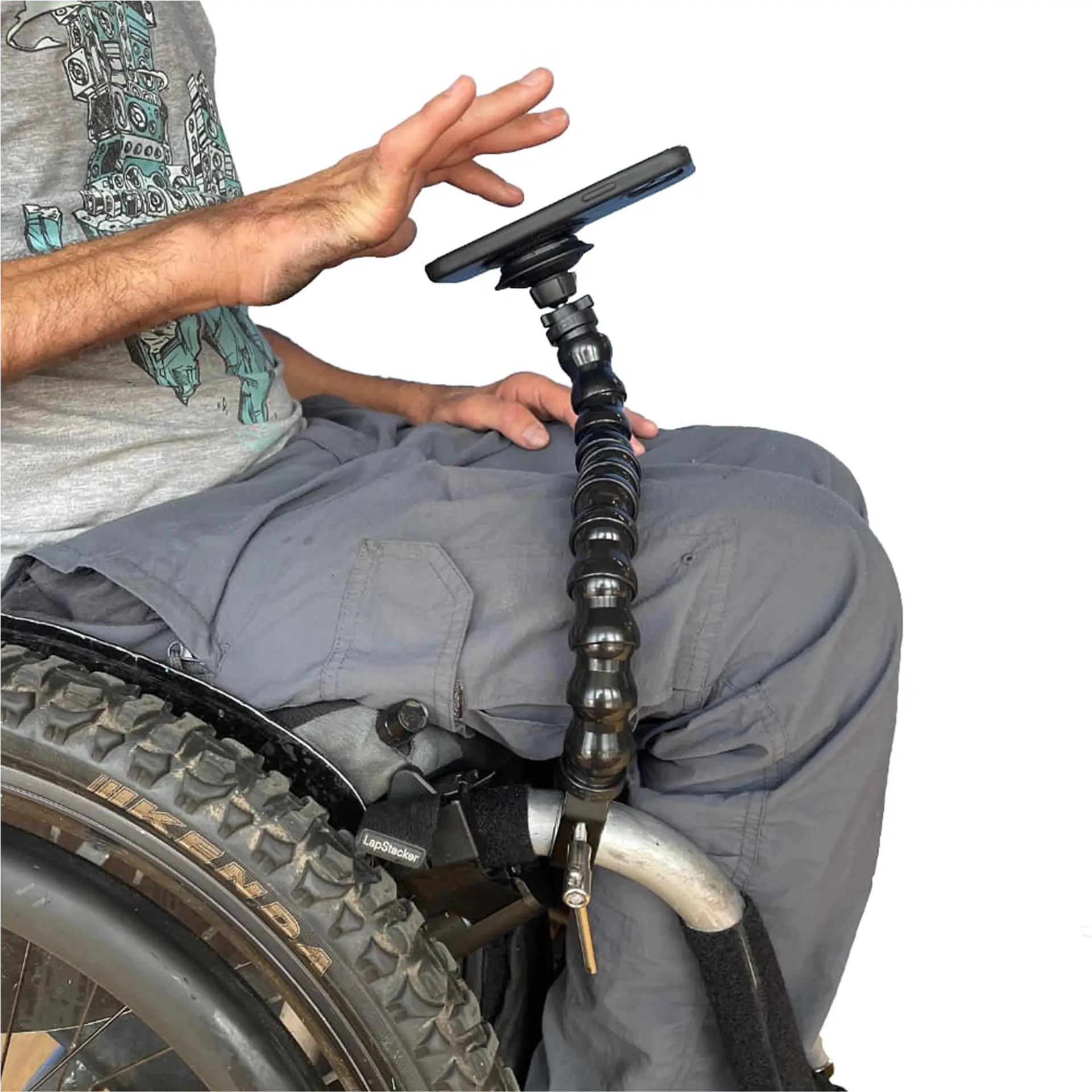 Person in wheelchair with phone mount arm attached near the wheel.
