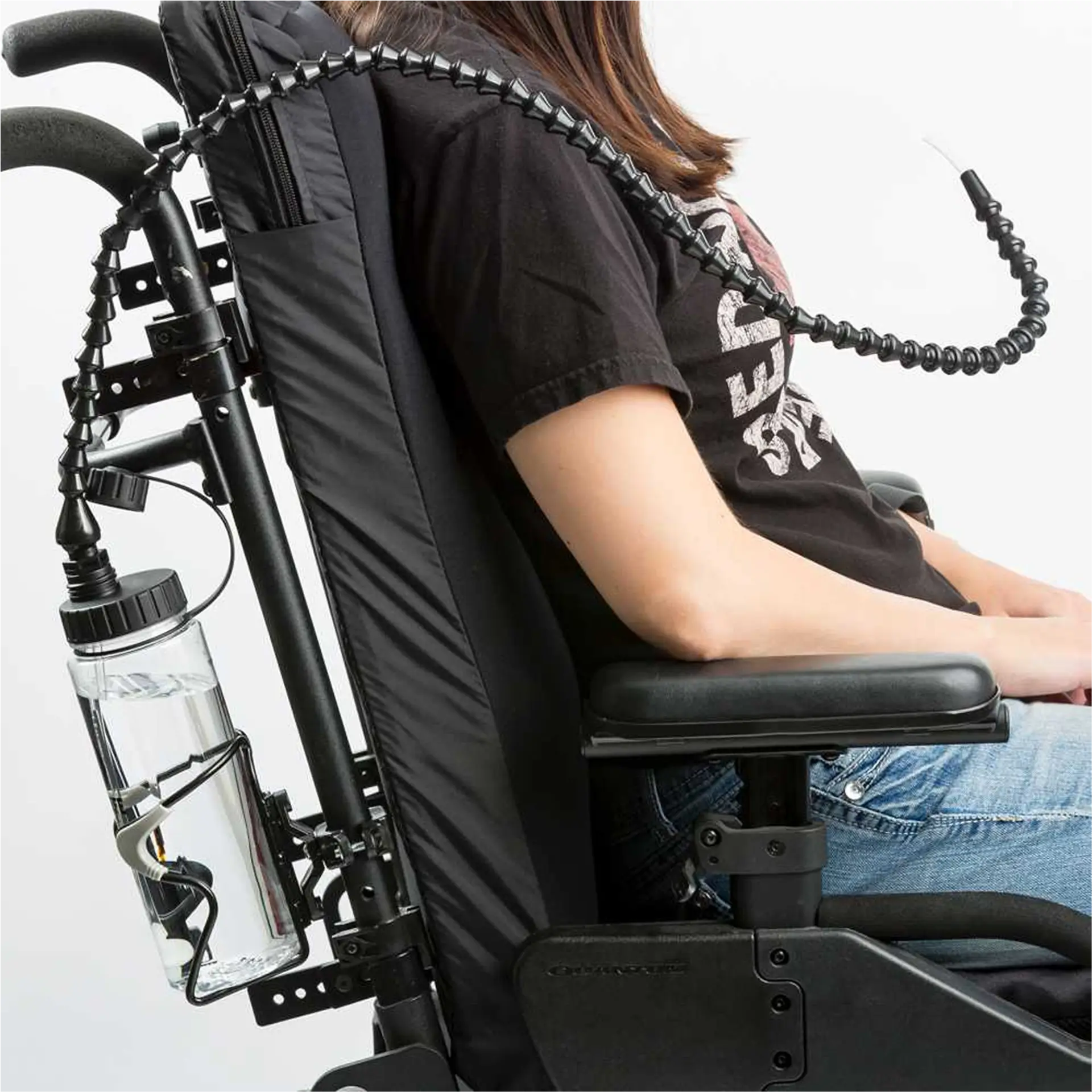 Water bottle mounted on flexible arm attached to back of wheelchair.